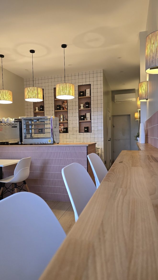The pastry counter and pink wall from the seating area