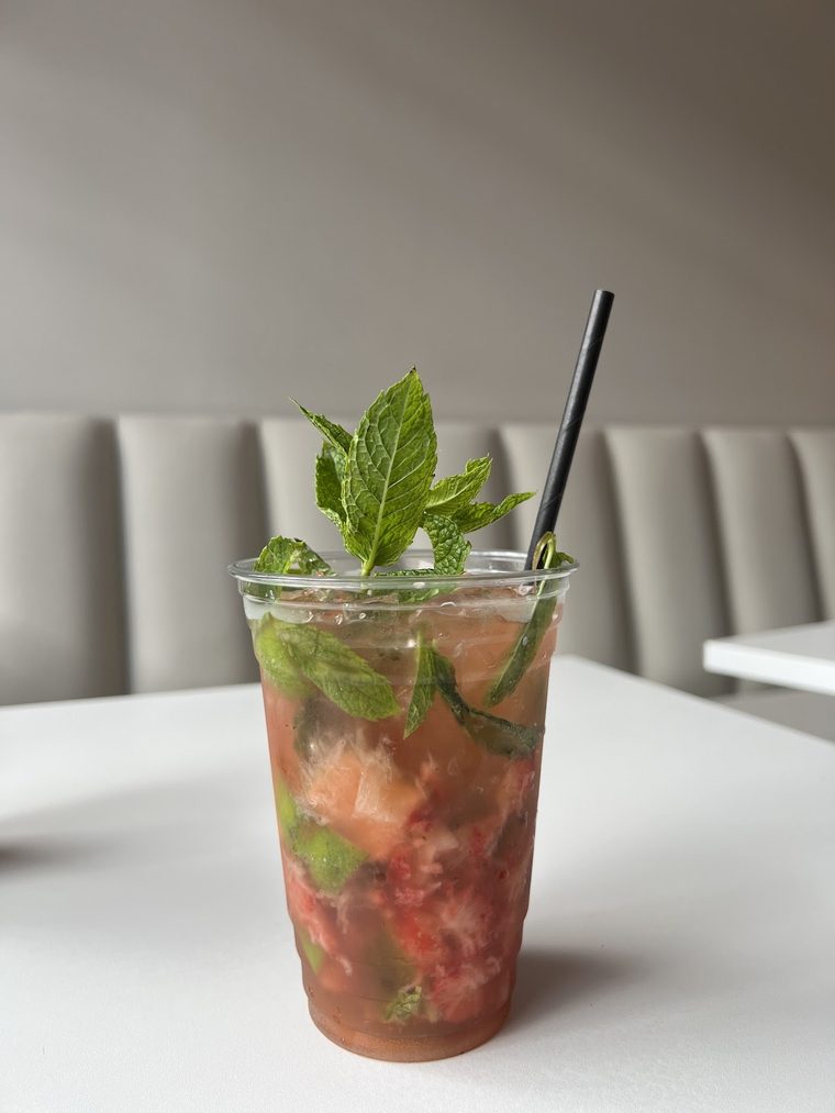 Mint and red-fruit cold drink in a tall cup